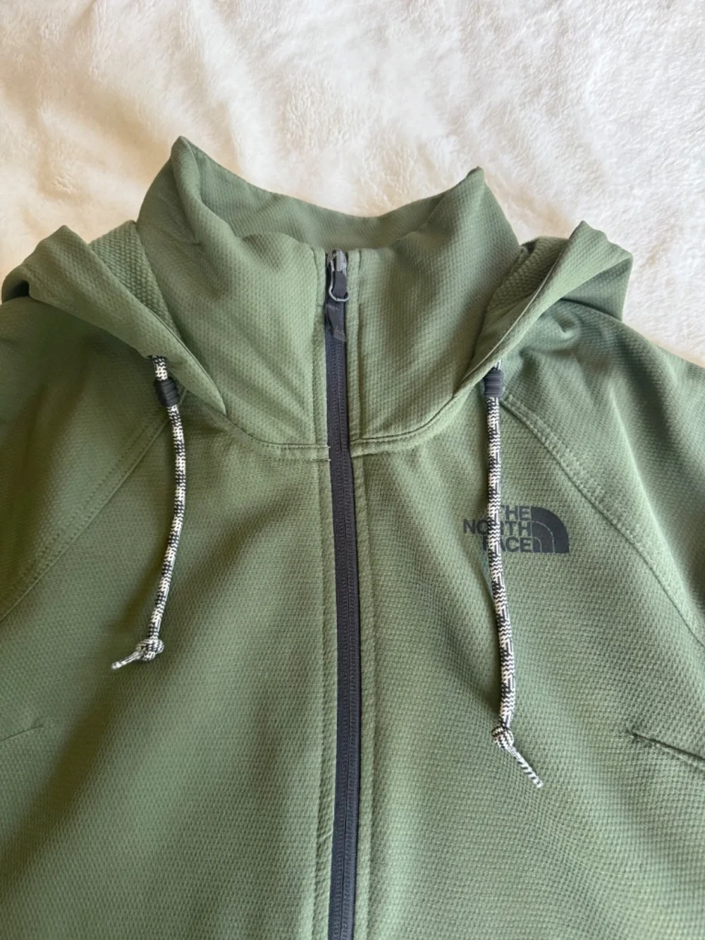 olive green The North Face Tekno Ridge Hoodie features a kangaroo pocket